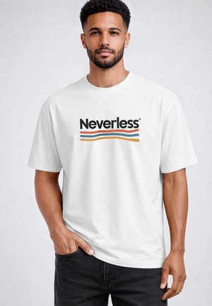 Man with short curly hair and beard wearing a white t-shirt with "Neverless" text and three colored wavy lines below it.