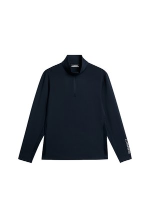 Marineblauwe pullover met lange mouwen, een hoge kraag en een kwart rits. Heeft zijslitsen en witte logo tekst op de linkermouw. Zachte stoftextuur.