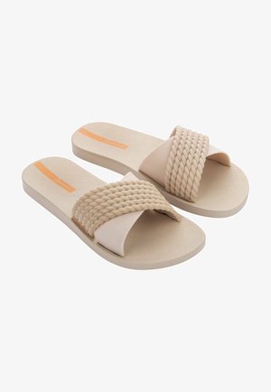 Sandali color beige chiaro con una fascia intrecciata e suola liscia. Presentano una soletta texturizzata e un sottile accento arancione nella zona delle dita.