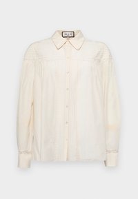 Cream, button-up blouse with a collar, featuring vertical pleats and lace accents on shoulders and cuffs. Soft fabric with long sleeves.