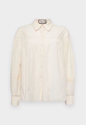 Cream, button-up blouse with a collar, featuring vertical pleats and lace accents on shoulders and cuffs. Soft fabric with long sleeves.