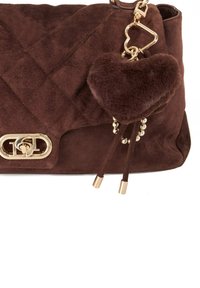 Brown suede handbag with quilted design, gold-tone hardware, and a heart-shaped fur charm attached with decorative beads and strings.