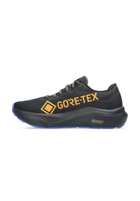 Black running shoe with a textured upper, GORE-TEX logo in orange, green laces, and a cushioned sole with a blue accent. 3D Guidance System detail.