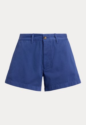 Sinised kõrge vöökohaga puuvillased lühikesed püksid, millel on ees nööpidega kinnis, vööaasad ja küljetaskud ühevärvilise tausta ees.