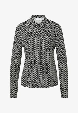 Zwart-witte langermige shirt met een geometrisch kettingpatroon, knoopsluiting aan de voorkant en klassieke kraag. Zachte stofstructuur.