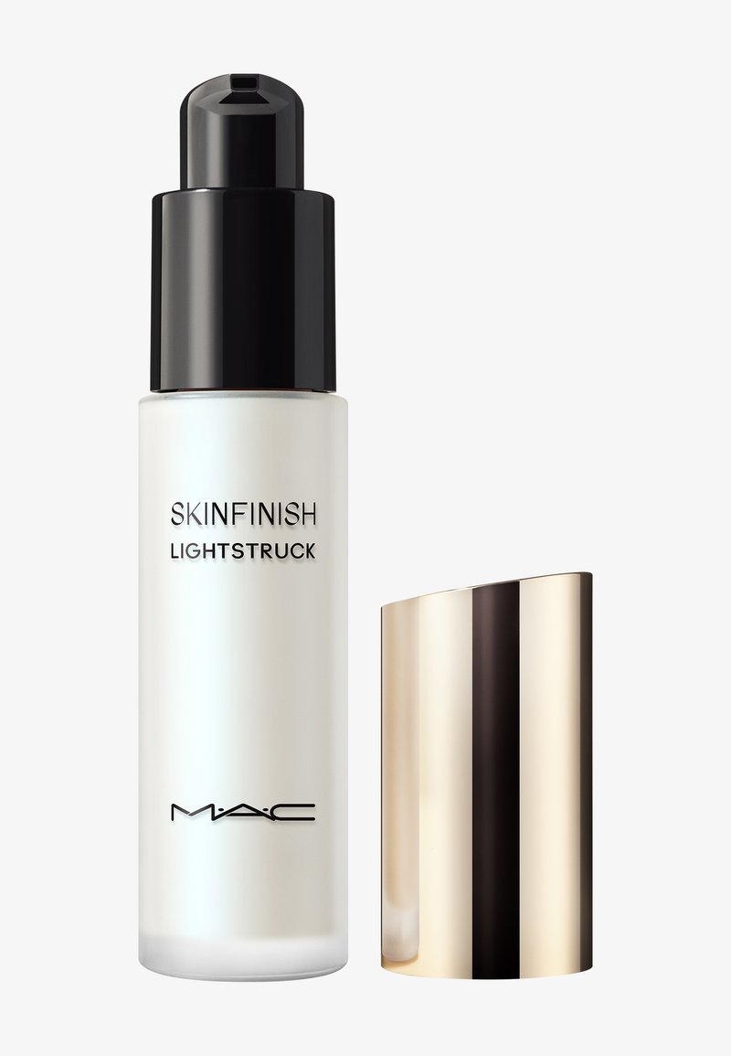MAC Skinfinish Lightstruck liquid highlighter bottle with black pump and removed gold reflective cap on white background.