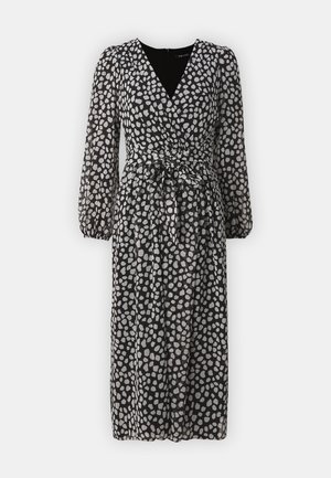 Schwarzes Kleid mit V-Ausschnitt und langen, puffärmeligen Ärmeln. Der Stoff hat ein graues Punktmuster und einen Bindegürtel in der Taille.