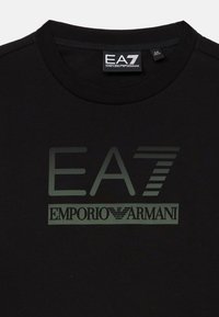 Svart t-skjorte med rund hals som har "EA7 Emporio Armani" logo i mørkegrått på fronten.