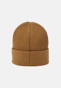 Brown knit beanie with a structured ribbed design, featuring a rolled cuff and seamless top, made from soft, textured fabric.
