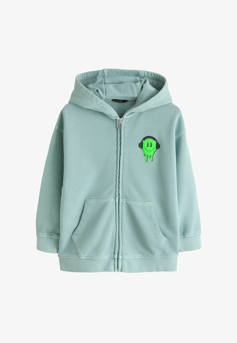 Zelena svetlo modra majica s kapuco z zadrgo, sprednjimi žepekoma in majhnim zelenim motivom talilnega obraza s slušalkami na prsih.