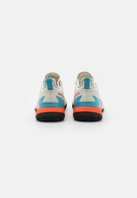 Buty sportowe z białą siateczkową cholewką, niebieskimi akcentami na pięcie i pomarańczowym śródpodeszwem. Wyposażone w teksturowaną czarną podeszwę dla lepszej przyczepności.