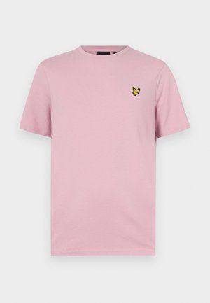 Rosa kortärmad t-shirt i mjukt tyg, med en liten gul fjärilslogotyp broderad på vänster bröst.