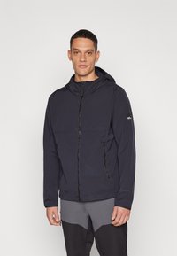 Marineblå vindjakke med glidelås foran, justerbar hette og to sidelommer. Glatt tekstur og minimalistisk design.