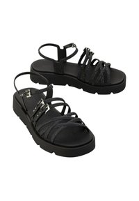 Sandali neri con suola texturizzata, caratterizzati da molteplici cinturini incrociati, fibbie regolabili e una piattaforma chunky. Inclusi dettagli scintillanti.