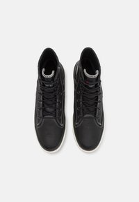 Black high-top sneakers with a textured leather finish, white stitching, and black laces. Rubber soles and padded openings for comfort.