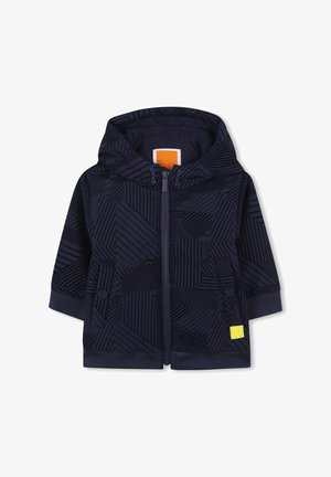 Mornarska zip-up kapuca s geometrijskimi vzorci, mehkega blaga, rebrastimi manšeti in malim rumenim logotipom na sprednji levi strani.