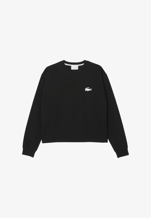 Svart kort sweatshirt i bomull med rund halsringning, långa ärmar och en liten vit broderad Lacoste-logotyp på bröstet.