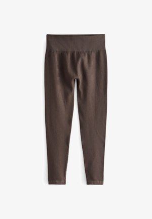 Leggings marroni a coste con una cintura larga ed elastica. Il tessuto è liscio e il design è aderente, che si stringe alla caviglia.