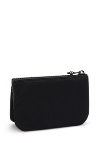 Sort nylon pouch med en glat tekstur, lynlåslukning og subtile stikdetaljer. Kompakt rektangulær form med afrundede kanter.