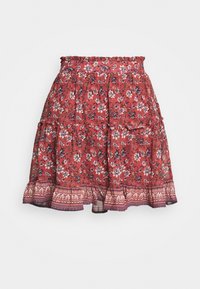 Röd blommig kjol med elastisk midja, tärningsdesign och kontrasterande mönstrad nederkant. Tillverkad av lättviktsmaterial med en mjuk textur.