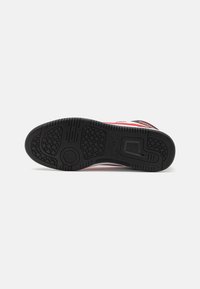 Black rubber sole with textured grip. Features colorful accents and a sleek design, showcasing a balanced shape and smooth surface.