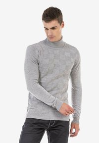 Grijze coltrui van gebreide stof, met een gestructureerd vierkant patroon, geribde manchetten en een geribde zoom. Ontworpen met een slim fit.