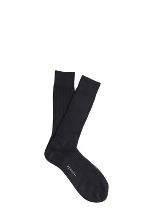 Calze nere a coste, realizzate in materiale morbido e di colore uniforme. Presentano una punta liscia e un bordo elasticizzato. Nome del marchio stampato sulla suola.