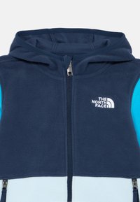Gilet in pile di The North Face in blu navy con accenti azzurri e turchesi. Caratterizzato da una chiusura anteriore con zip completa e doppie tasche con zip.