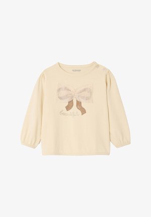 Long-sleeve cream shirt with a bow applique in light pink and brown. Features a round neckline and button detail on the shoulder.