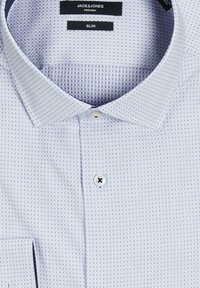 Cămașă slim-fit bleu deschis, realizată dintr-un material texturat, cu un model de carouri mici, închidere cu nasturi și detalii contrastante la gulerul interior.