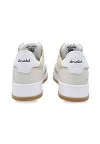 White and beige sneakers with a smooth leather and suede upper, featuring a textured heel, and a rubber outsole with a light brown tread.