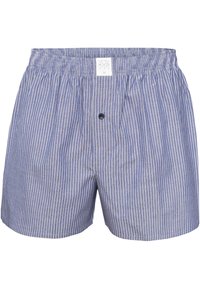 Boxer shorts en coton rayés bleus et blancs avec une taille élastique, une ouverture à boutons, et une petite étiquette de marque à l'avant.