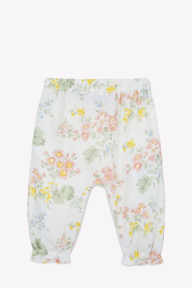 Pantalones de algodón con estampado floral y cintura elástica, con un fondo blanco y flores de colores múltiples en rosa, amarillo y verde.