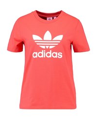 Koralové bavlněné tričko s kulatým výstřihem, s velkým bílým logem Adidas ve tvaru trojlístku a textem na přední straně. Krátké rukávy, jednobarevné.