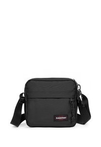 Černá crossbody taška Eastpak vyrobená z odolného nylonu. Obsahuje hlavní přihrádku na zip, přední kapsu a nastavitelný popruh.