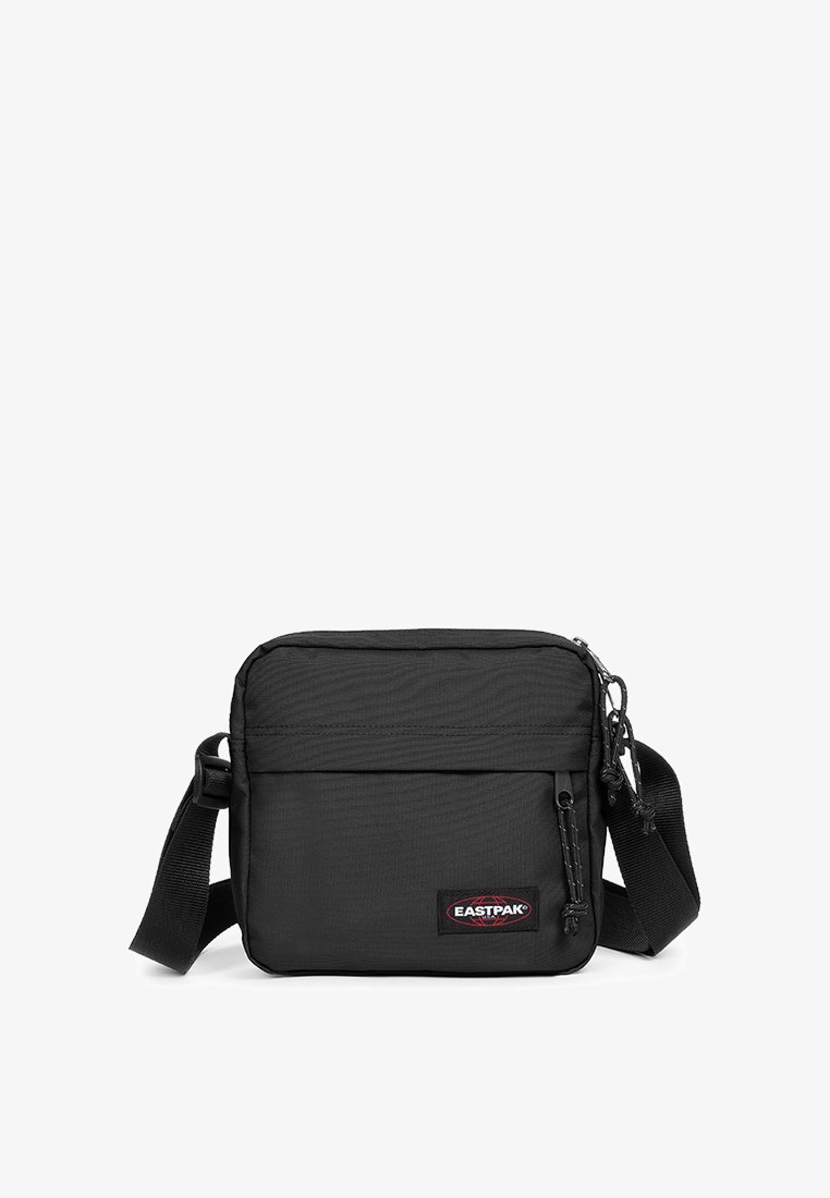 Borsa a tracolla nera Eastpak realizzata in nylon resistente. Presenta un compartimento principale con zip, una tasca frontale e una tracolla regolabile.