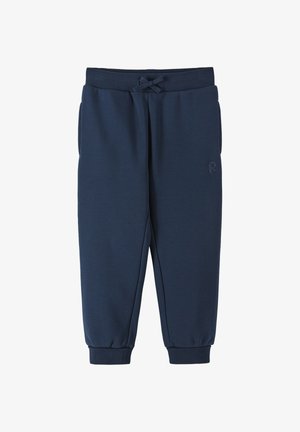 Granatowe dziecięce spodnie dresowe z elastycznym pasem, przednimi kieszeniami, sznurkiem, ściągaczami przy kostkach i subtelnym logo na udzie.