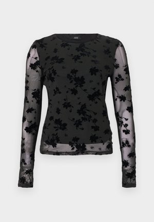 Zwarte top met lange mouwen van doorschijnende stof, met een bloemmotief. Gestructureerde zwarte accenten aan mouwen en halslijn.