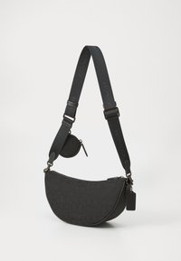 Schwarze Schultertasche mit einer geschwungenen Form, strukturiertem Stoff, verstellbarem Tragegurt mit Logo und angehängtem runden Reißverschlussbeutel.