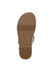 Lichtblauwe schoen met een textuur bovenkant, gebogen zool en een gladde bruine rubberen buitenzool. Plat ontwerp met subtiele branding aan de onderkant.