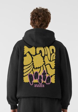 Black hoodie featuring a yellow pasta graphic on the back, with accent text in pink. Material appears soft; design has a playful theme.