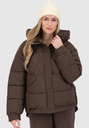 Brown puffer jacket with a hood, featuring diagonal quilted patterns and snap buttons. Worn with a cream beanie, presenting a casual look.