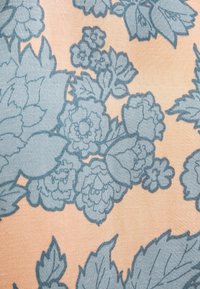 Tessuto con motivo che presenta grandi fiori e foglie blu su uno sfondo pesca, con dettagli texture e forme floreali variabili.