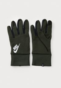 Zöld kötött kesztyű fekete ujjakra tapadó fel�ülettel. Fehér Nike logóval a csuklón, szoros mandzsettával és áramvonalas kialakítással rendelkezik.