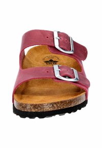 Pink leather sandals with two adjustable silver buckles, cork footbed, and textured black rubber sole, featuring a smooth finish and open design.