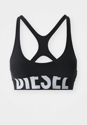 Soutien-gorge de sport noir avec un design dos nageur et une large bande élastique arborant le mot "DIESEL" en lettres blanches épaisses. Texture lisse.