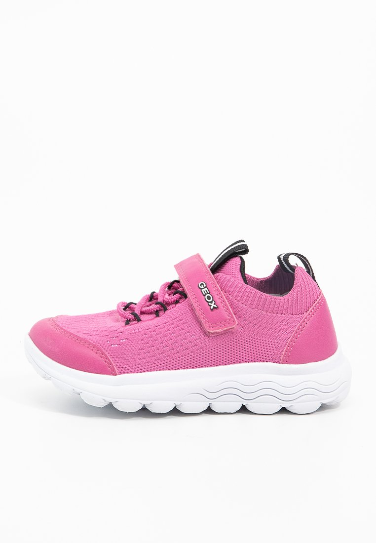 Sneaker rosa per bambini in maglia con suola bianca, lacci elastici neri e un fascetta in Velcro rosa con l'etichetta "Geox."