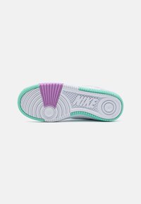 White sneaker sole with a textured pattern; mint green and purple accents on the heel and midsole. Features circular and horizontal grooves.