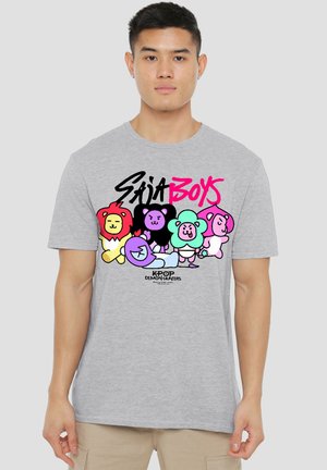 Young man wearing a gray t-shirt with colorful cartoon animals and text saying "Saia Boys" and "KPOP Demon Hunters" on front.