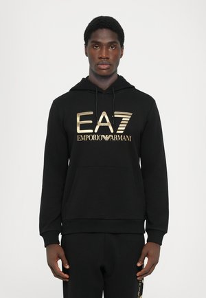 Black hoodie made of soft material featuring a prominent gold EA7 Emporio Armani logo. Includes a kangaroo pocket and adjustable drawstring hood.